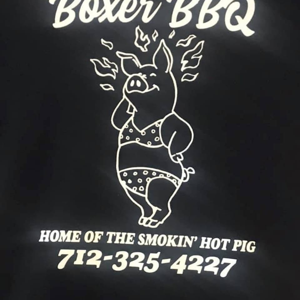 Boxer BBQ logo with a pig in a polka-dot bikini, surrounded by flames, and contact information.