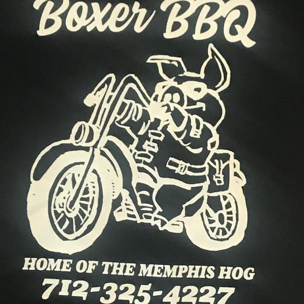 Boxer BBQ logo featuring a pig riding a motorcycle, with "Home of the Memphis Hog" and a phone number.